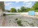 Large backyard featuring grass, sand, a shed, and a white privacy fence at 131 N Central Ave, Apopka, FL 32703