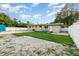 Large backyard featuring grass, sand, a shed, and a patio at 131 N Central Ave, Apopka, FL 32703