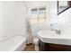 Bright bathroom with a shower and tub, and a dark colored wood vanity at 131 N Central Ave, Apopka, FL 32703