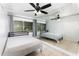 Bright bedroom with tile flooring, fan, neutral walls, and a window with curtains for natural light at 131 N Central Ave, Apopka, FL 32703