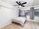 Bedroom with tile flooring, fan, neutral walls, and a window with curtains for natural light at 131 N Central Ave, Apopka, FL 32703