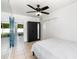 Bedroom featuring tile floors, a ceiling fan, and a glass door to the outside at 131 N Central Ave, Apopka, FL 32703