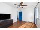 Bright bedroom with blue doors, light colored walls, and wood floors at 131 N Central Ave, Apopka, FL 32703