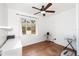 Bright bedroom with a ceiling fan, a window, and a white curtain at 131 N Central Ave, Apopka, FL 32703