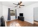 Bedroom with hardwood flooring, a ceiling fan, and a window with curtains at 131 N Central Ave, Apopka, FL 32703