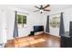 Bedroom with hardwood flooring, ceiling fan, neutral walls, and a window with curtains at 131 N Central Ave, Apopka, FL 32703