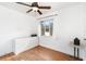 Bright bedroom with a ceiling fan, a window, and a white dresser at 131 N Central Ave, Apopka, FL 32703