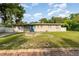 Charming single-story home with an attached garage and quaint landscaping in a residential neighborhood at 131 N Central Ave, Apopka, FL 32703