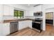 This is a modern kitchen with stainless steel appliances and white cabinetry at 131 N Central Ave, Apopka, FL 32703