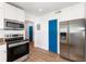 Bright kitchen featuring stainless steel appliances, white cabinets, and wood-look flooring at 131 N Central Ave, Apopka, FL 32703
