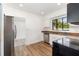 Well-lit kitchen featuring modern appliances, granite countertops, and wood-look flooring at 131 N Central Ave, Apopka, FL 32703