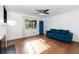 Bright living room with hardwood floors, a ceiling fan, and an accent-colored door at 131 N Central Ave, Apopka, FL 32703