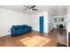Spacious living room featuring hardwood floors, a stylish couch, and access to the dining area at 131 N Central Ave, Apopka, FL 32703