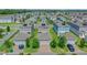 Aerial view of properties with solar panels, manicured lawns, and paver driveways in a well-kept community at 1378 Roxy Ln, Winter Garden, FL 34787