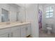 Bright bathroom with double vanity and shower at 1378 Roxy Ln, Winter Garden, FL 34787