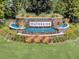 Waterside entrance with a waterfall feature and colorful landscaping at 1378 Roxy Ln, Winter Garden, FL 34787