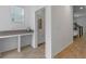 Hallway featuring a built-in desk area, a window and tile flooring at 1378 Roxy Ln, Winter Garden, FL 34787