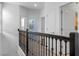 Upstairs hallway with a dark railing and access to several rooms at 1378 Roxy Ln, Winter Garden, FL 34787