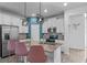 Modern kitchen featuring white cabinets, a center island with seating, and stainless steel appliances at 1378 Roxy Ln, Winter Garden, FL 34787