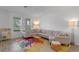 Comfortable living room with large sectional sofa, colorful rug, and bright natural light at 1378 Roxy Ln, Winter Garden, FL 34787