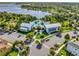 Aerial view of a community pool with a clubhouse, palm trees, and lounge chairs near a scenic lake at 1378 Roxy Ln, Winter Garden, FL 34787