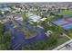 Aerial view of the community featuring a pool, tennis courts, and parking at 14164 Swanley St, Orlando, FL 32832