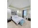 Bright bedroom featuring a queen-size bed, bedside table, and modern decor at 14164 Swanley St, Orlando, FL 32832