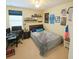 A cozy bedroom is adorned with personal touches, including posters, a desk, and ample shelving at 14164 Swanley St, Orlando, FL 32832