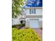 Charming townhome with a one-car garage, colorful landscaping, and a welcoming red tile roof at 14164 Swanley St, Orlando, FL 32832