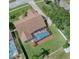 An aerial view showing the home's layout with screened pool, landscaping, and extended driveway at 14322 Pine Cone Trl, Clermont, FL 34711
