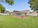 The spacious backyard features a screened pool, green lawn, and storage shed, perfect for outdoor living at 14322 Pine Cone Trl, Clermont, FL 34711