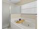 This bathroom has a large bathtub, a shower, and a window for lots of natural light at 14322 Pine Cone Trl, Clermont, FL 34711