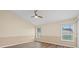 Bright bedroom with neutral walls, wood-look floors, and plenty of natural light at 14322 Pine Cone Trl, Clermont, FL 34711