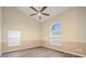 Bright bedroom with wood floors, ceiling fan, and large windows offering plenty of natural light at 14322 Pine Cone Trl, Clermont, FL 34711