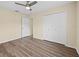 This is a bright bedroom featuring neutral walls, wood-look flooring, and a ceiling fan at 14322 Pine Cone Trl, Clermont, FL 34711