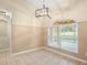 Cozy dining area with tile floors, modern light fixture, and views of the pool through the window at 14322 Pine Cone Trl, Clermont, FL 34711