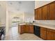 Kitchen with tile flooring, stainless steel appliances, and adjacent dining area with natural light at 14322 Pine Cone Trl, Clermont, FL 34711