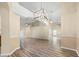Spacious open-plan living area with wood floors, high ceilings, and modern pendant lighting fixtures at 14322 Pine Cone Trl, Clermont, FL 34711