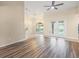 Spacious area with wood floors, ample natural light, and access to the pool area through glass doors at 14322 Pine Cone Trl, Clermont, FL 34711