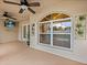Covered patio featuring ceiling fans, an arched window, and outdoor decor at 14322 Pine Cone Trl, Clermont, FL 34711