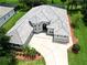 Aerial view of a well-maintained single-story home with a tile roof, lush landscaping, and a wide driveway at 1441 Foxtail Ct, Lake Mary, FL 32746