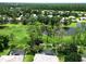 This aerial view features lush landscaping, serene ponds and a partial view of a screened-in pool at 1441 Foxtail Ct, Lake Mary, FL 32746