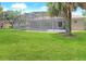 A spacious backyard with lush green grass and screened in pool for outdoor enjoyment at 1441 Foxtail Ct, Lake Mary, FL 32746