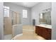 A luxurious bathroom with a glass shower, soaking tub, and modern cabinets at 1441 Foxtail Ct, Lake Mary, FL 32746