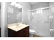 Bathroom featuring shower with glass door, stylish vanity, large mirror, decorative window and toilet at 1441 Foxtail Ct, Lake Mary, FL 32746
