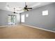 Large bedroom with a carpeted floor, tray ceiling with dual fans, and multiple windows for plenty of natural light at 1441 Foxtail Ct, Lake Mary, FL 32746