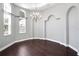 Dining room showcasing hardwood floors, arched doorway, chandelier and natural light from the windows at 1441 Foxtail Ct, Lake Mary, FL 32746