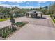 Gated community entrance with lush landscaping, a picturesque pond and a fountain at 1441 Foxtail Ct, Lake Mary, FL 32746