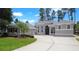 Stunning single-story home with a neutral color scheme, complemented by lush landscaping and a wide driveway at 1441 Foxtail Ct, Lake Mary, FL 32746