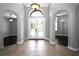 Foyer with tile floors, arched entryways, and a decorative glass double front door that fills the space with light at 1441 Foxtail Ct, Lake Mary, FL 32746